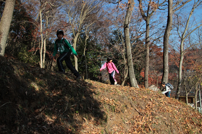 急な斜面を登る子どもたちの写真