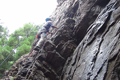 男岩南面のフェースを登るＣさんの写真