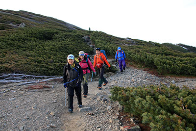 蝶ヶ岳の山頂稜線を歩いている写真