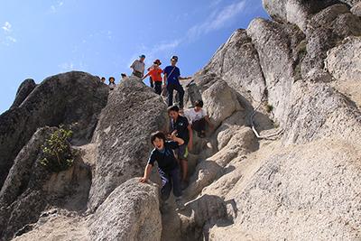 花崗岩の岩場を下っている子どもたちの写真